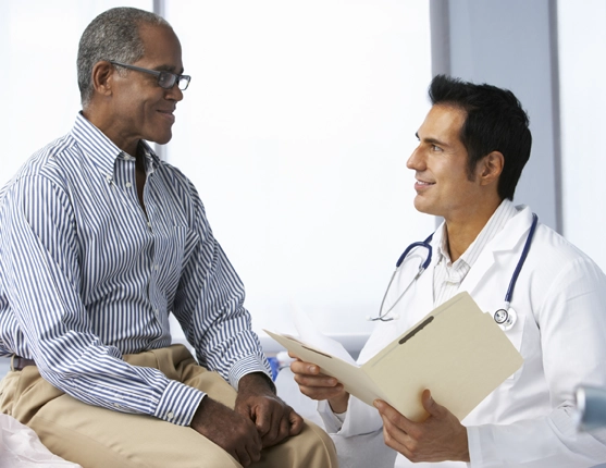 Image: Dr. and black male patient talking